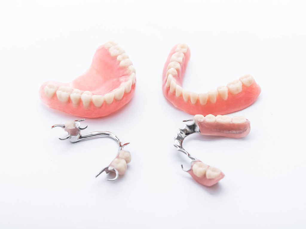 full and partial dentures laying next to each other